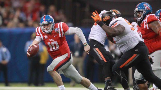 Jan 1, 2016; New Orleans, LA, USA; Mississippi Rebels quarterback Chad Kelly (10) carries the ball against the Oklahoma State Cowboys during the third quarter in the 2016 Sugar Bowl at the Mercedes-Benz Superdome. Mandatory Credit: Crystal LoGiudice-USA TODAY Sports